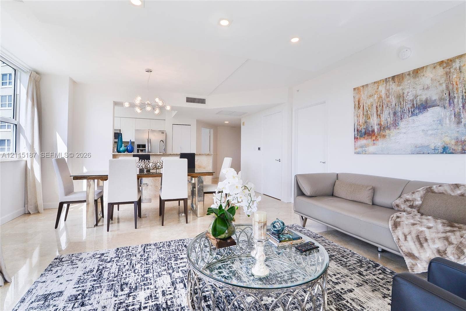19501 W Country Club Drive, #504, Aventura, Aventura, FL 33180 Open-concept interior featuring light stone flooring, recessed lighting, and a multi-globe chandelier