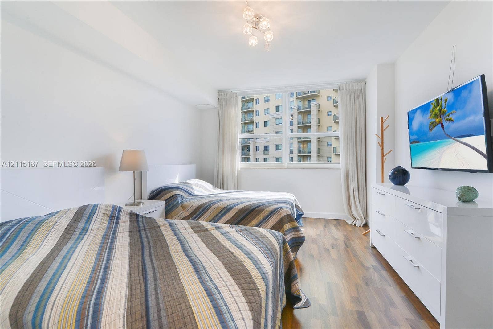 19501 W Country Club Drive, #504, Aventura, Aventura, FL 33180 Room featuring large multi-pane windows, wood-finish flooring, and a contemporary multi-bulb ceiling fixture