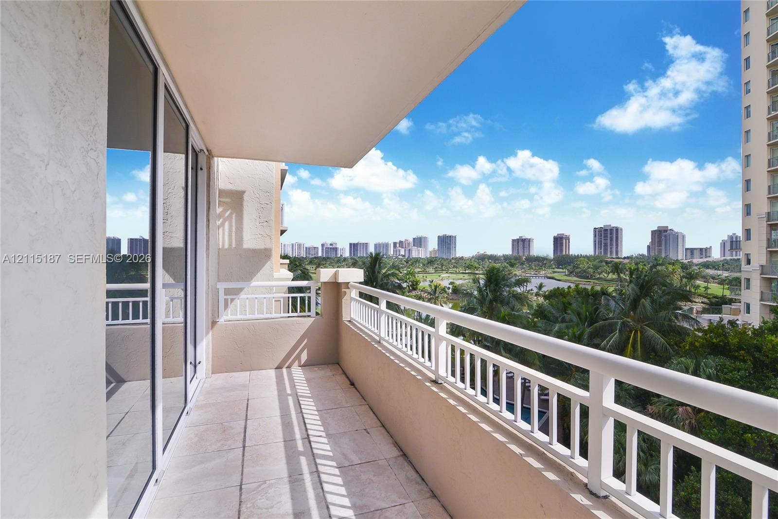 19501 W Country Club Drive, #504, Aventura, Aventura, FL 33180 Covered balcony featuring tile flooring, metal railings, and floor-to-ceiling glass sliding doors