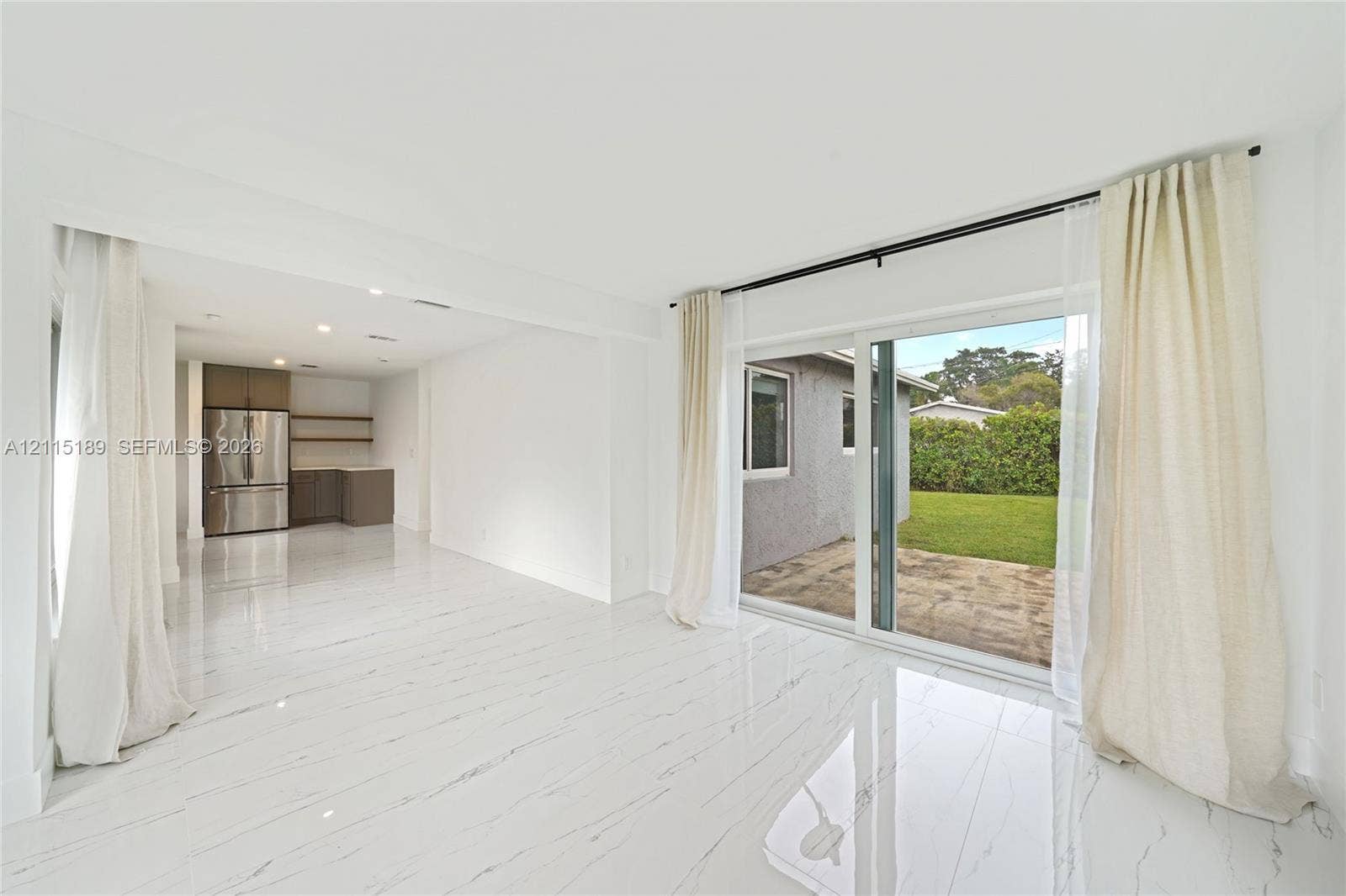 2111 N 14th Court, Hollywood, Hollywood, FL 33020 Open-concept interior featuring light-toned flooring, recessed lighting, sliding glass doors, and stainless steel kitchen appliances
