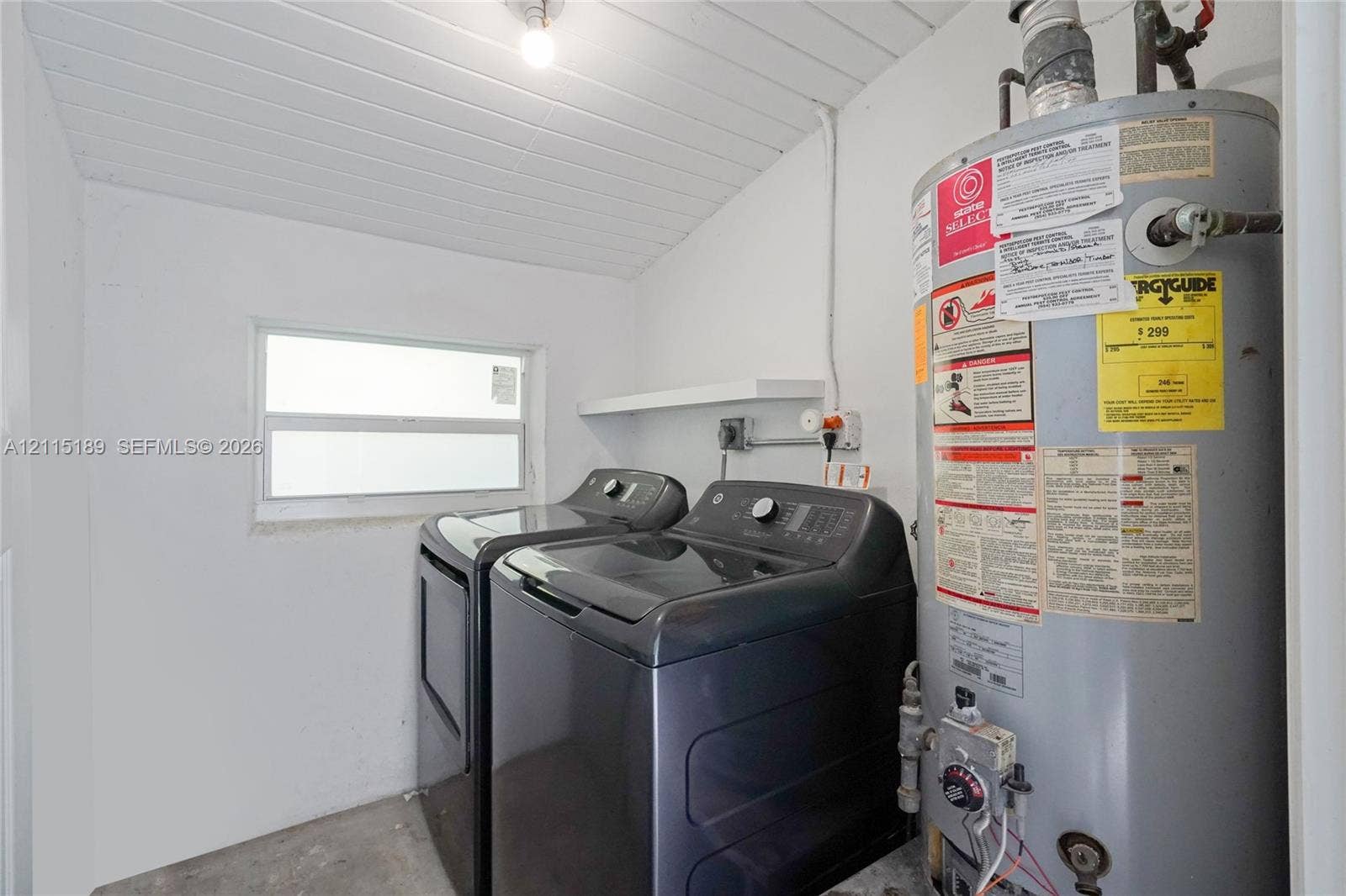 2111 N 14th Court, Hollywood, Hollywood, FL 33020 Utility space featuring a horizontal sliding window, beadboard ceiling, white wall finish, and a built-in wall shelf