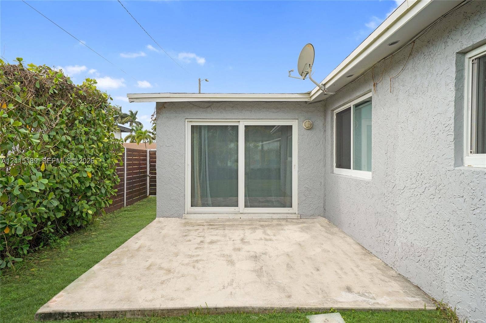 2111 N 14th Court, Hollywood, Hollywood, FL 33020 Concrete patio featuring sliding glass doors, stucco exterior walls, and privacy fencing