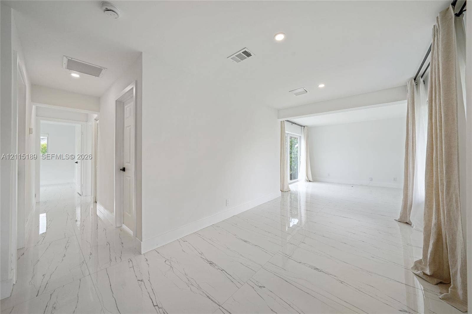 2111 N 14th Court, Hollywood, Hollywood, FL 33020 Polished stone-finish flooring with veining, recessed lighting, and crisp white wall finishes