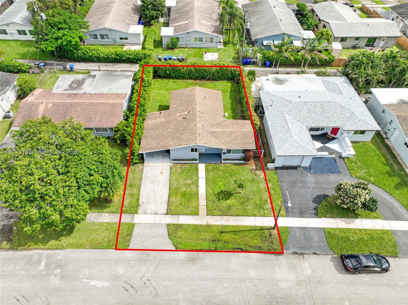 2111 N 14th Court, Hollywood, Hollywood, FL 33020 Single-story residence featuring a concrete driveway, structured landscaping, and a manicured lawn