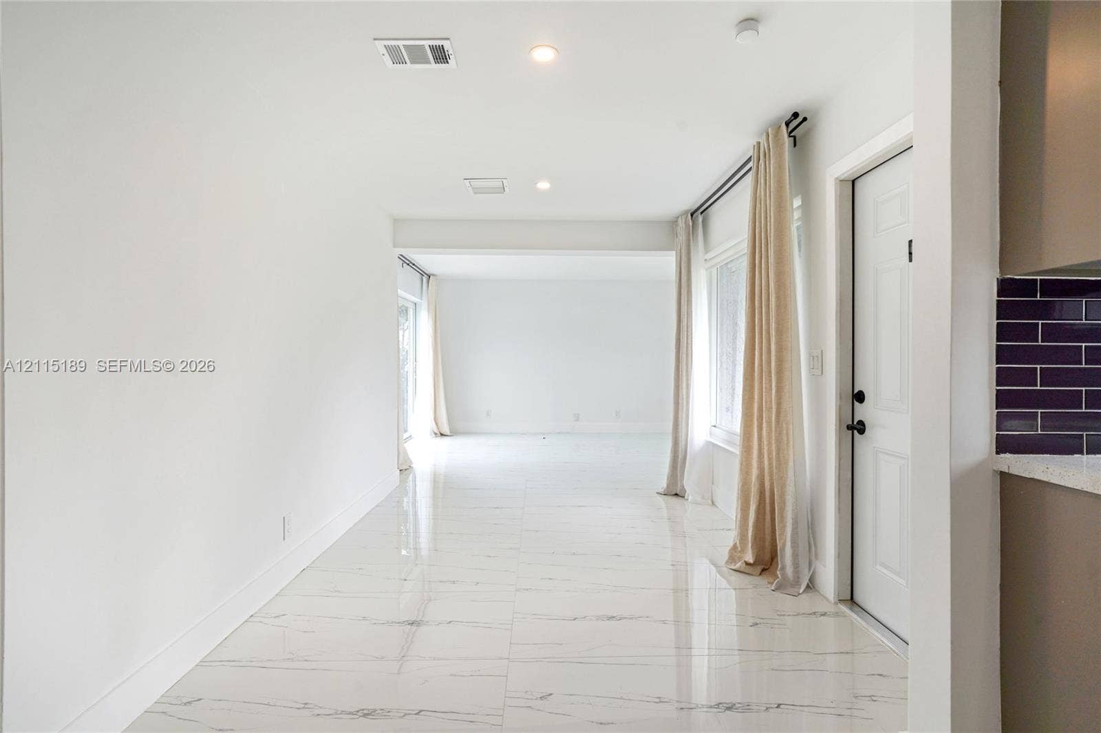 2111 N 14th Court, Hollywood, Hollywood, FL 33020 Open-concept living space featuring high-gloss, light-toned stone-finish tile flooring, recessed lighting, and a neutral color palette