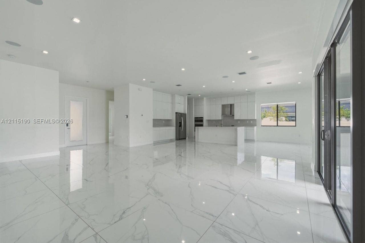 Open living area, kitchen and patio access.