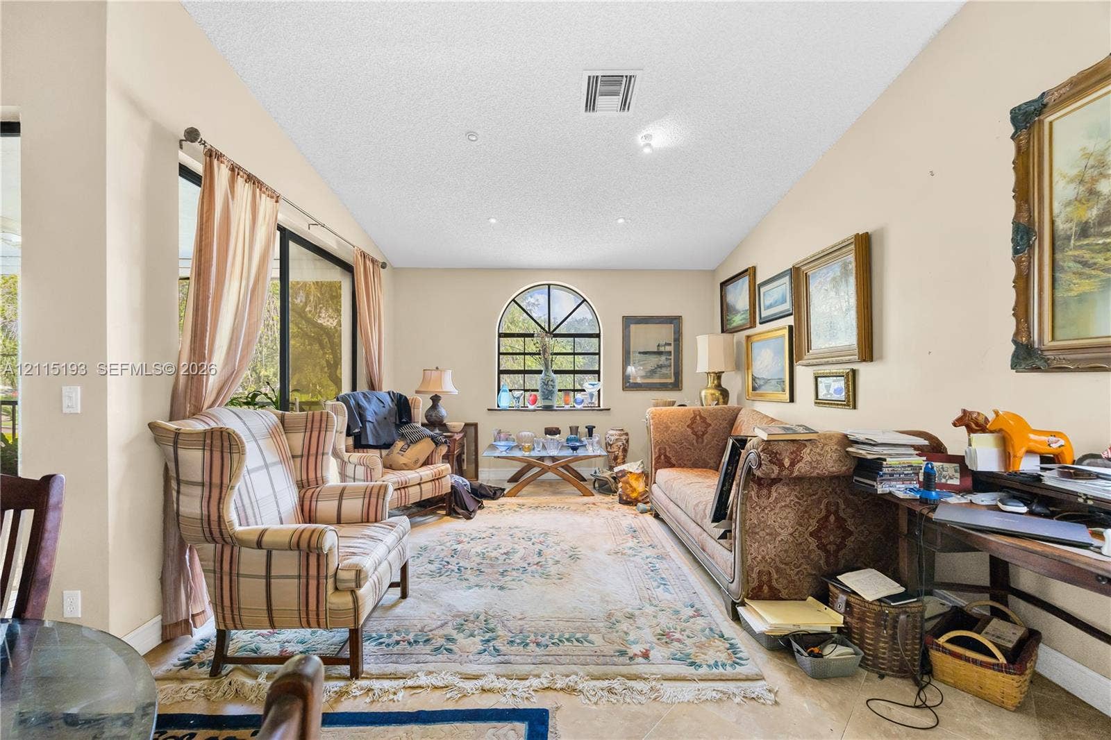 5422 Venetia Court, #G, Boynton Beach, FL 33437 Living area featuring an arched window, sliding glass door, recessed lighting, and tile flooring