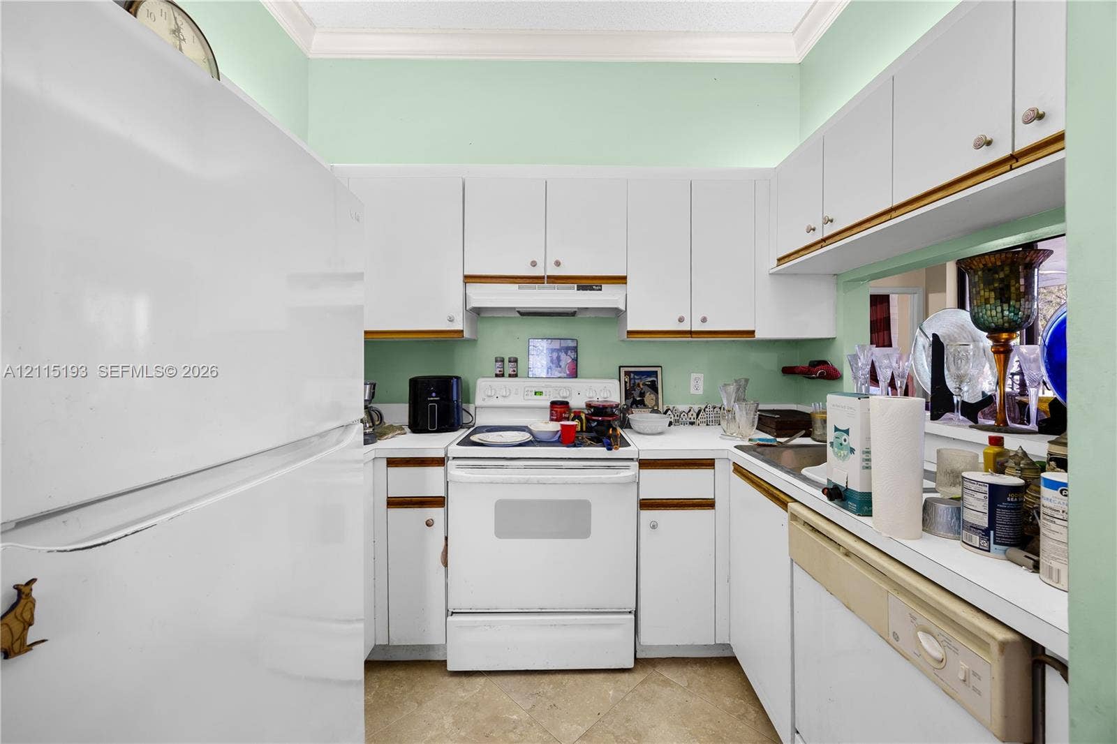 5422 Venetia Court, #G, Boynton Beach, FL 33437 Kitchen featuring white cabinetry, a built-in range, a dishwasher, and stone-finish tile flooring
