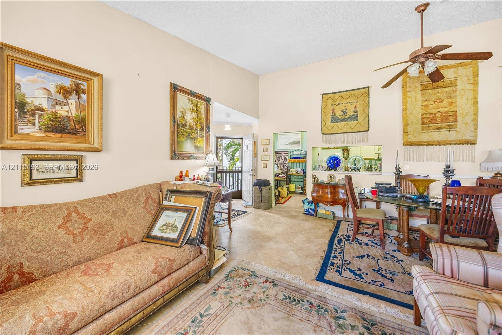 5422 Venetia Court, #G, Boynton Beach, FL 33437 High ceilings, neutral wall tones, tile flooring, and a ceiling fan with integrated lighting