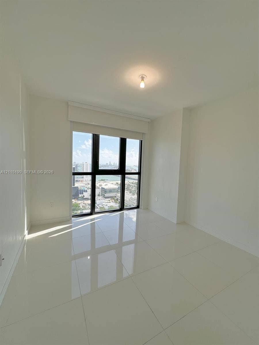 1600 NE 1st Avenue, #3120, Miami, FL 33132 Large-format tile flooring, floor-to-ceiling windows with black frames, and recessed lighting