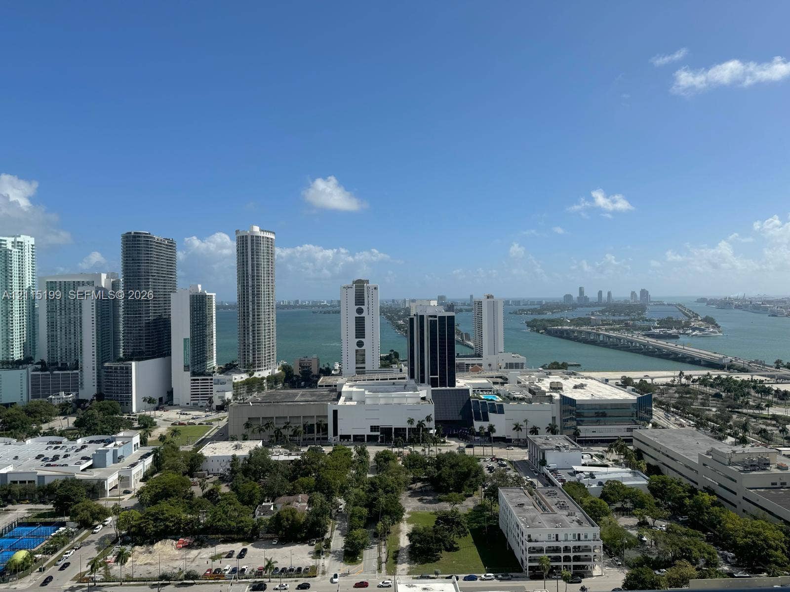 1600 NE 1st Avenue, #3120, Miami, FL 33132 Elevated perspective of the metropolitan skyline featuring expansive waterfront stretches, high-rise buildings, and bridge infrastructure