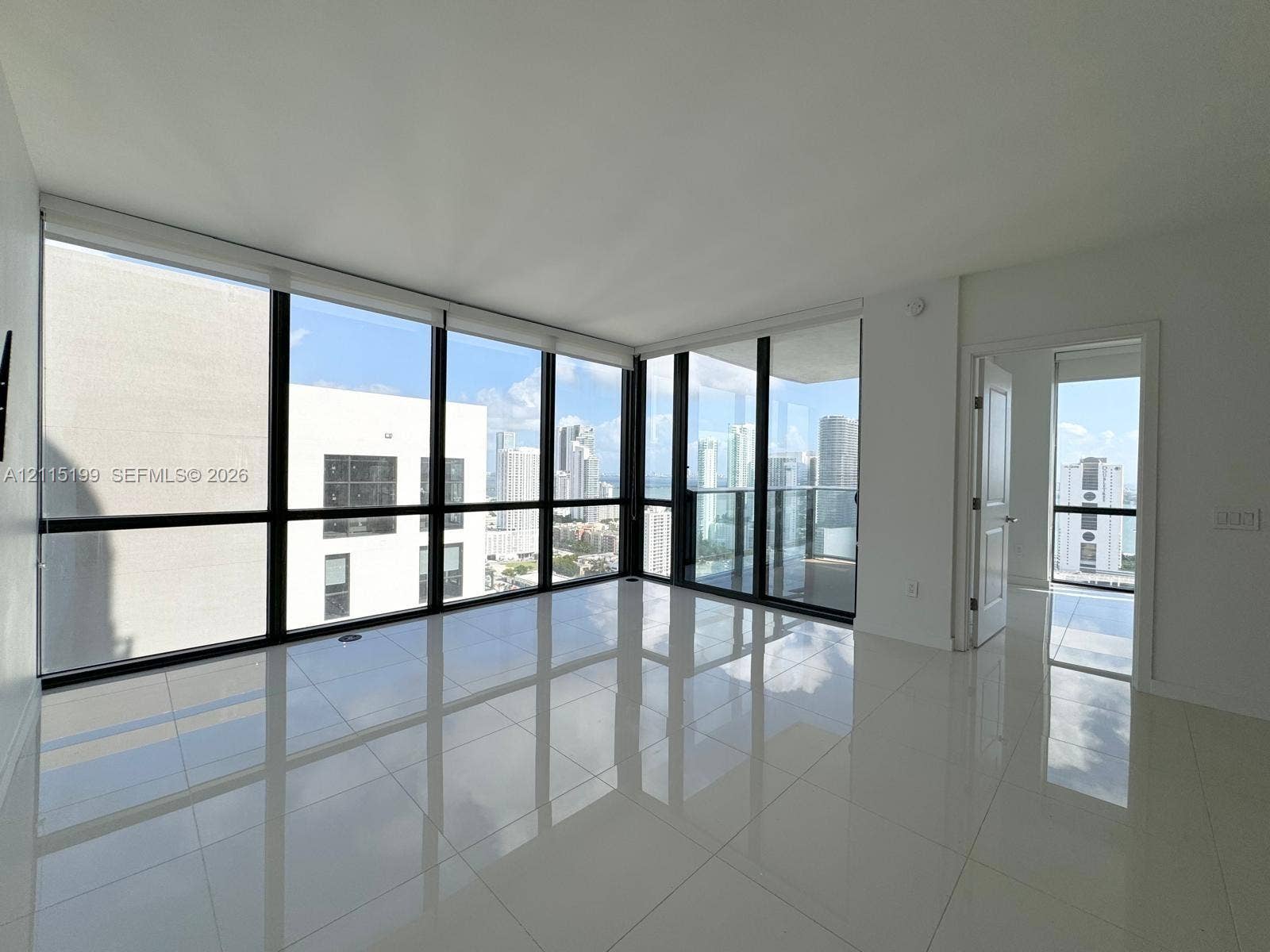 1600 NE 1st Avenue, #3120, Miami, FL 33132 Floor-to-ceiling windows, high-gloss tile flooring, and a glass-paneled balcony door