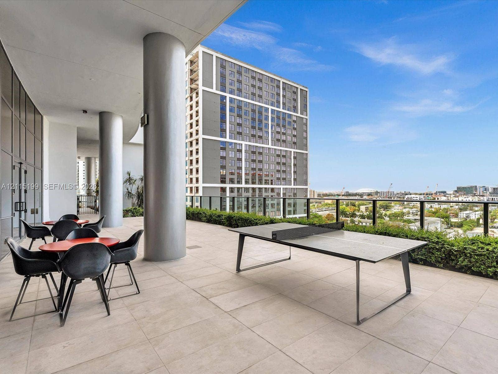 1600 NE 1st Avenue, #3120, Miami, FL 33132 Covered terrace featuring large-format tile flooring, structural columns, and glass-and-metal perimeter railings
