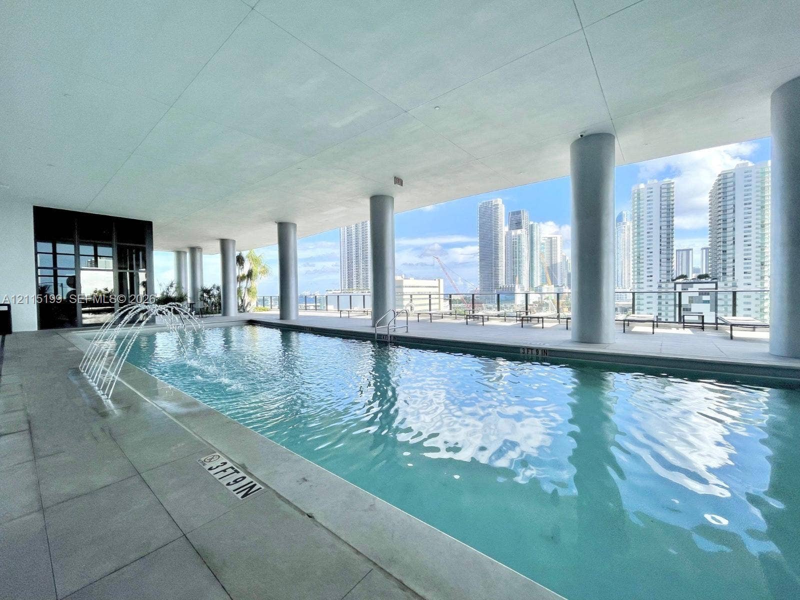 1600 NE 1st Avenue, #3120, Miami, FL 33132 Covered outdoor pool featuring a water fountain element, large-format tile decking, and structural support columns