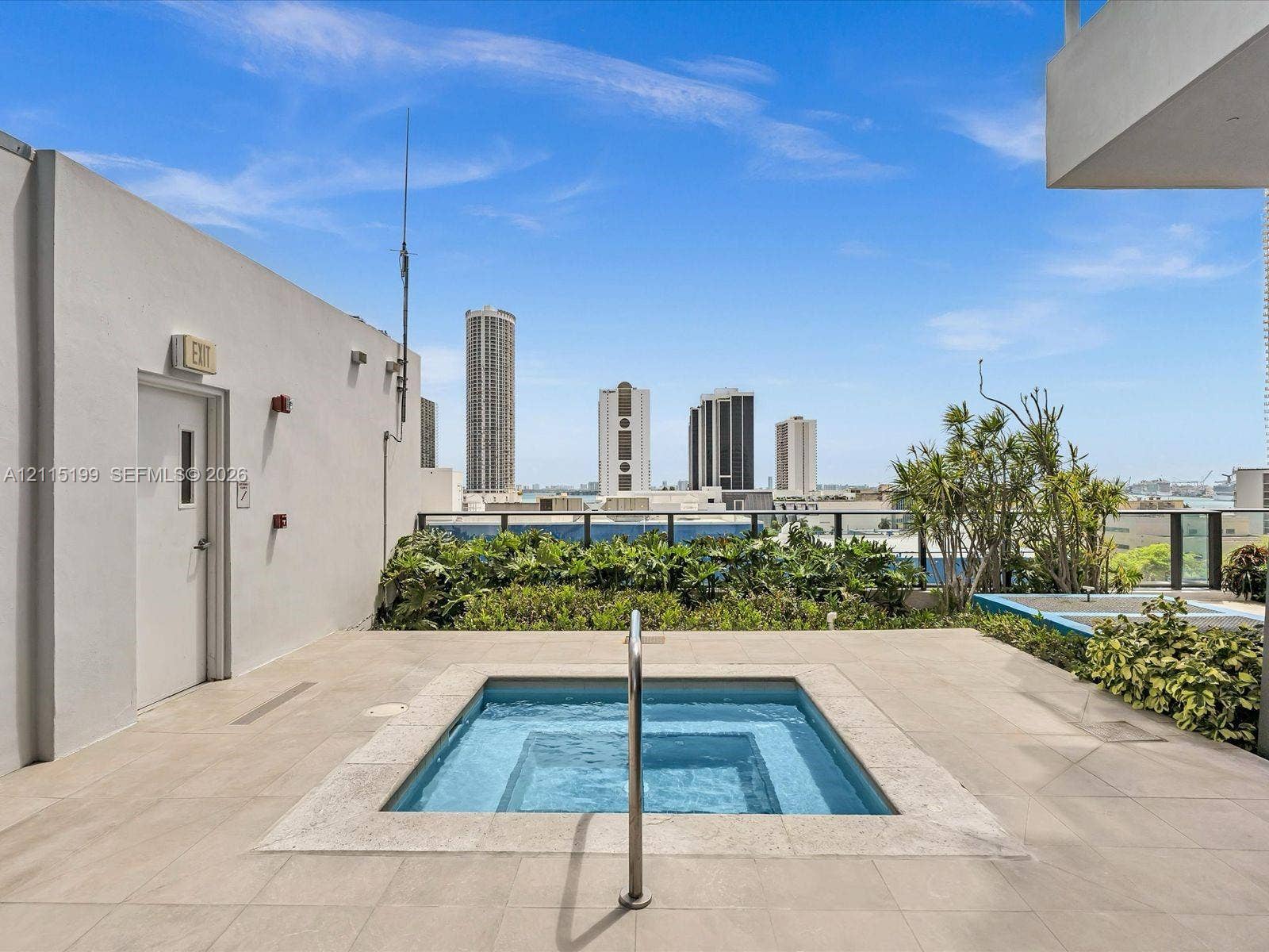 1600 NE 1st Avenue, #3120, Miami, FL 33132 Rooftop terrace featuring an in-ground spa, tiled flooring, integrated landscaping, and metal perimeter railing