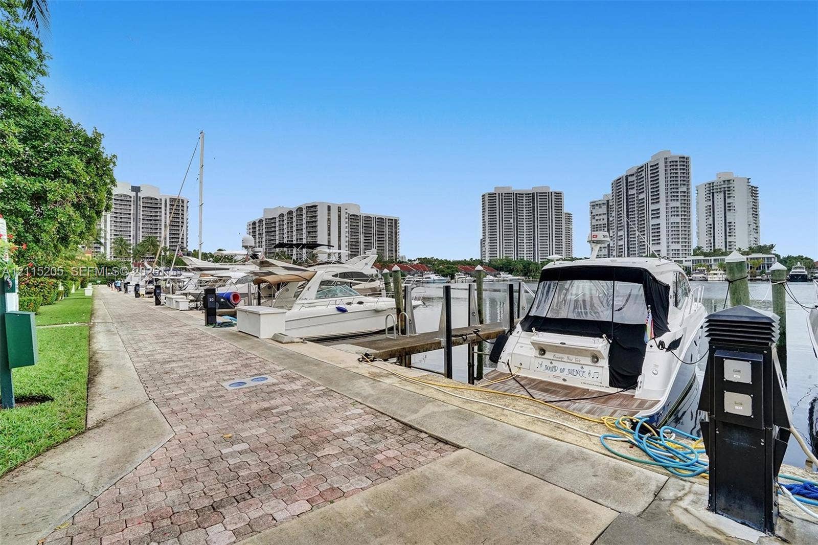 Deep-water marina featuring a paved stone walkway.