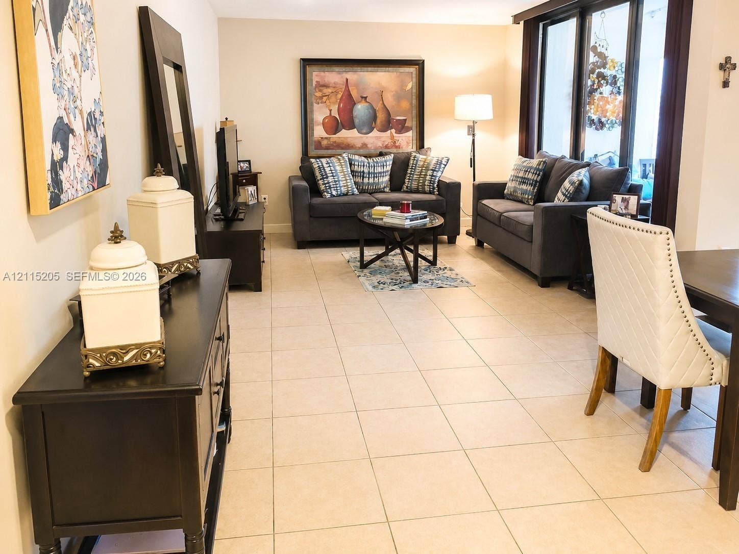 Ceramic tile flooring, floor to ceiling sliding doors leading to patio.