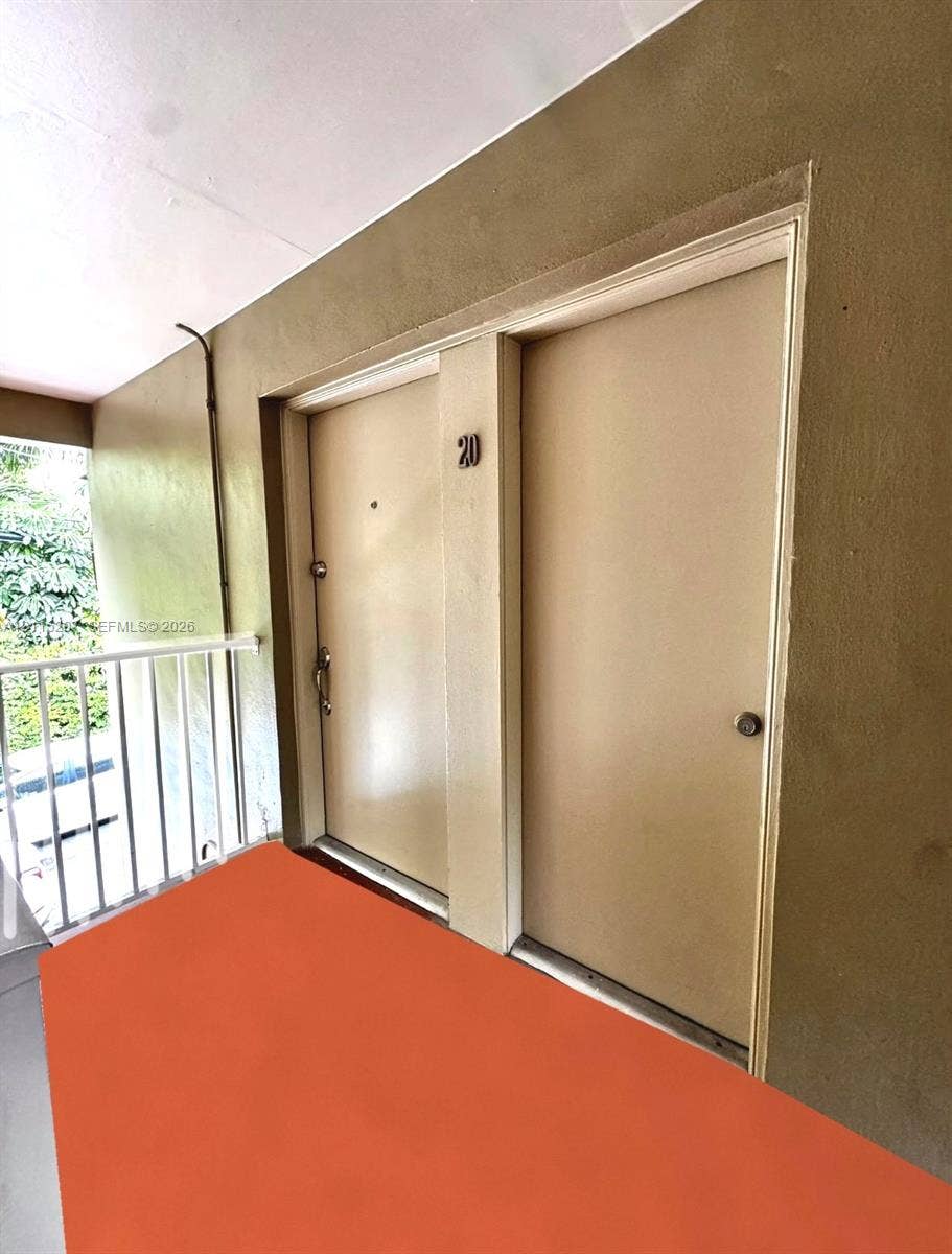 6330 SW 79th Street, #20, South Miami, South Miami, FL 33143 Exterior entry with painted stucco walls, dual access doors, and a metal safety railing