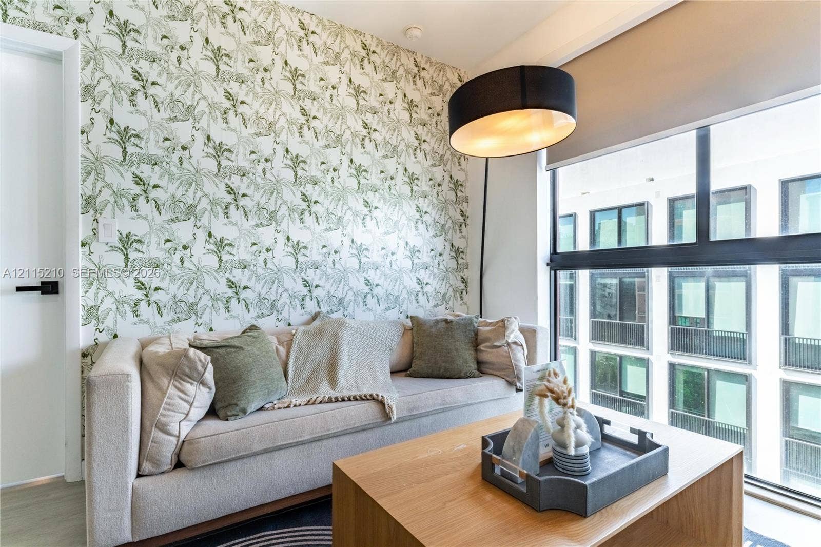 136 NW 26th Street, #507, Miami, FL 33127 Statement wall featuring patterned wallpaper, expansive multi-pane window, and modern black hardware