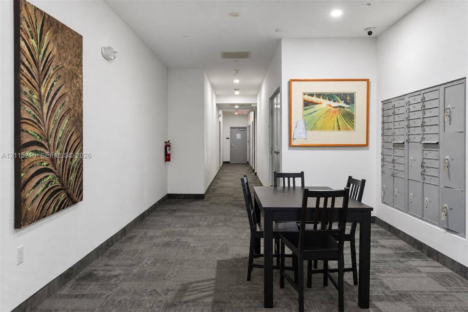 136 NW 26th Street, #507, Miami, FL 33127 Common area featuring neutral-toned carpeting, recessed ceiling lighting, and built-in metal parcel lockers