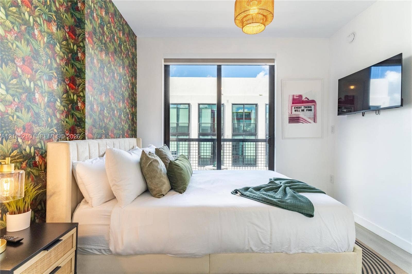136 NW 26th Street, #507, Miami, FL 33127 Floor-to-ceiling window with metal frame, patterned accent wall, and pendant lighting fixture