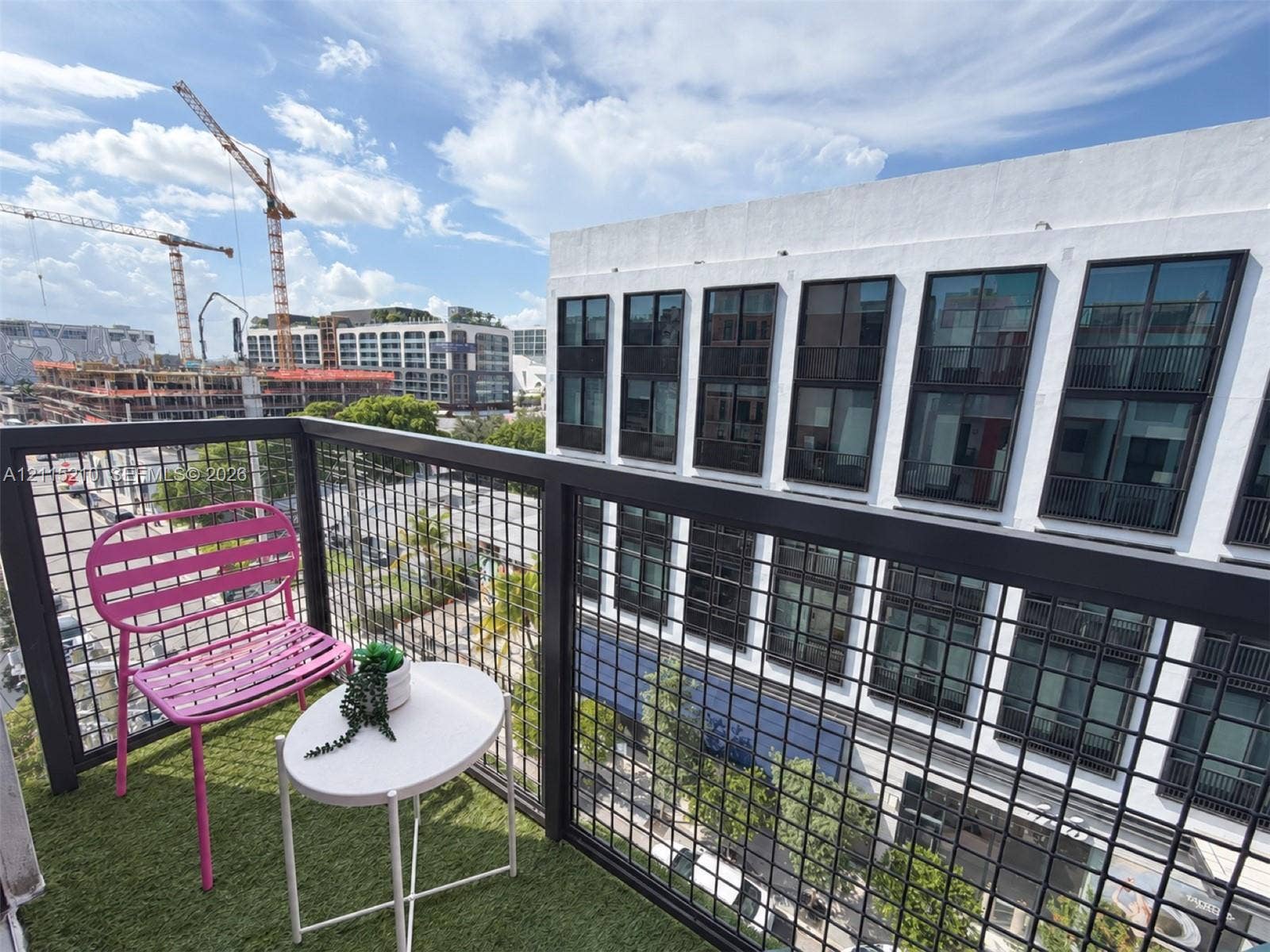 136 NW 26th Street, #507, Miami, FL 33127 Private balcony featuring synthetic turf flooring and a black metal grid railing