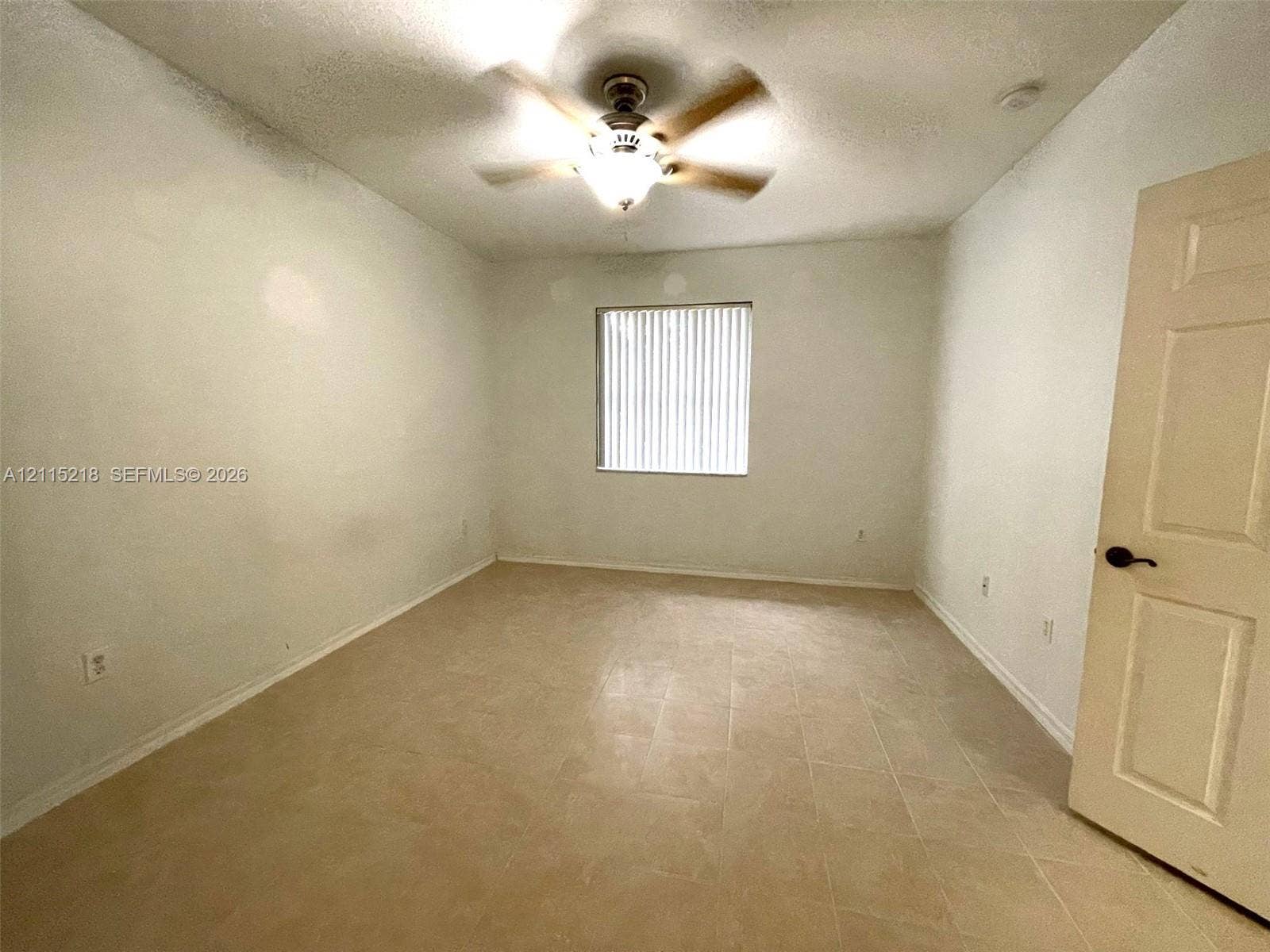 12738 SW 49th Court, #12738, Miramar, Miramar, FL 33027 Room with tile flooring, neutral walls, ceiling fan with integrated lighting, and vertical window blinds