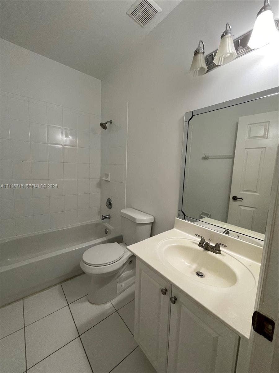 12738 SW 49th Court, #12738, Miramar, Miramar, FL 33027 Laundry area featuring a multi-pane window, white wire shelving, and tile flooring