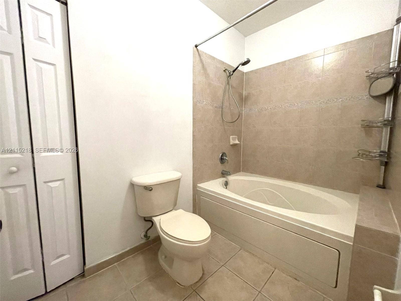 12738 SW 49th Court, #12738, Miramar, Miramar, FL 33027 Bathroom featuring a vanity with an integrated sink, a tiled tub-shower combination, a framed mirror, and a three-light fixture