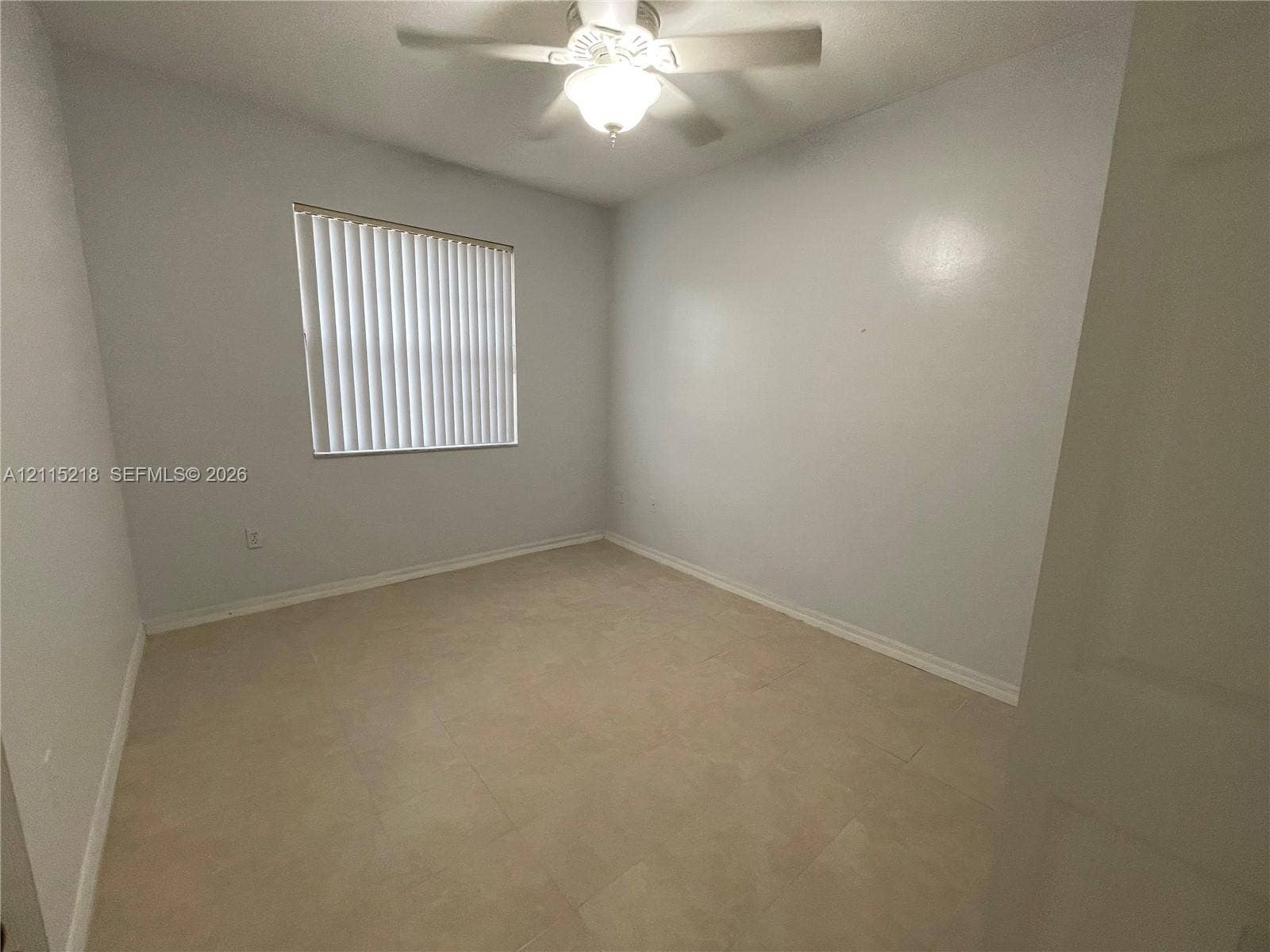 12738 SW 49th Court, #12738, Miramar, Miramar, FL 33027 Stamped concrete patio featuring a perimeter of privacy fencing, integrated metal gate, and surrounding mature landscaping