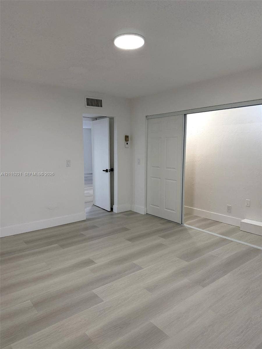 301 Bonaventure Boulevard, #15, Weston, FL 33326 Interior space featuring wood-finish flooring, recessed LED ceiling lighting, and a sliding-door closet