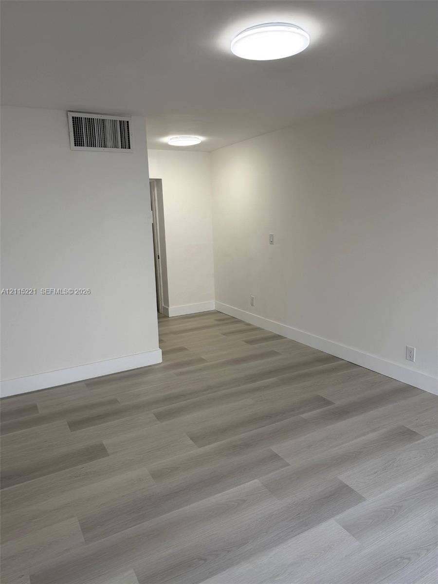 301 Bonaventure Boulevard, #15, Weston, FL 33326 Neutral interior space featuring wood-finish flooring, smooth white walls, and flush-mount ceiling lighting