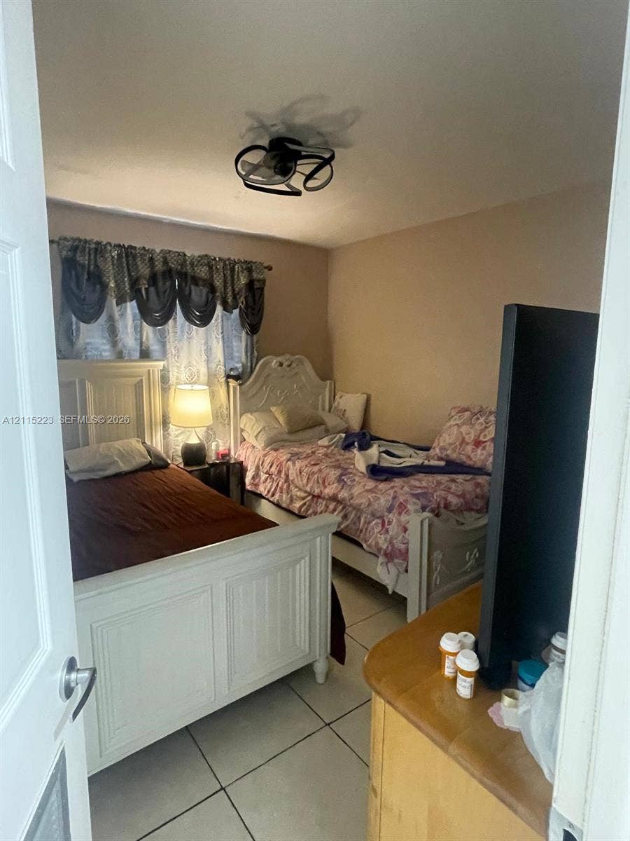 737 SE 8th Place, Hialeah, FL 33010 Neutral-toned interior featuring ceramic tile flooring and a multi-blade ceiling fan fixture