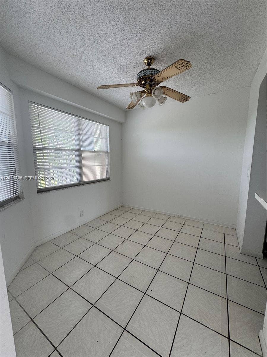 12950 SW 7th Court, #404A, Pembroke Pines, Pembroke Pines, FL 33027 Ceramic tile flooring, multi-pane windows with horizontal blinds, and a central ceiling fan with integrated lighting