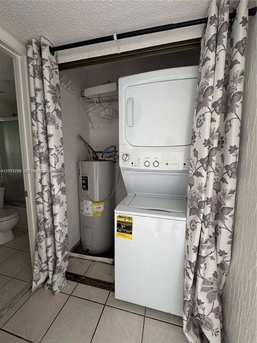 12950 SW 7th Court, #404A, Pembroke Pines, Pembroke Pines, FL 33027 Stacked laundry unit with an integrated water heater and wire shelving