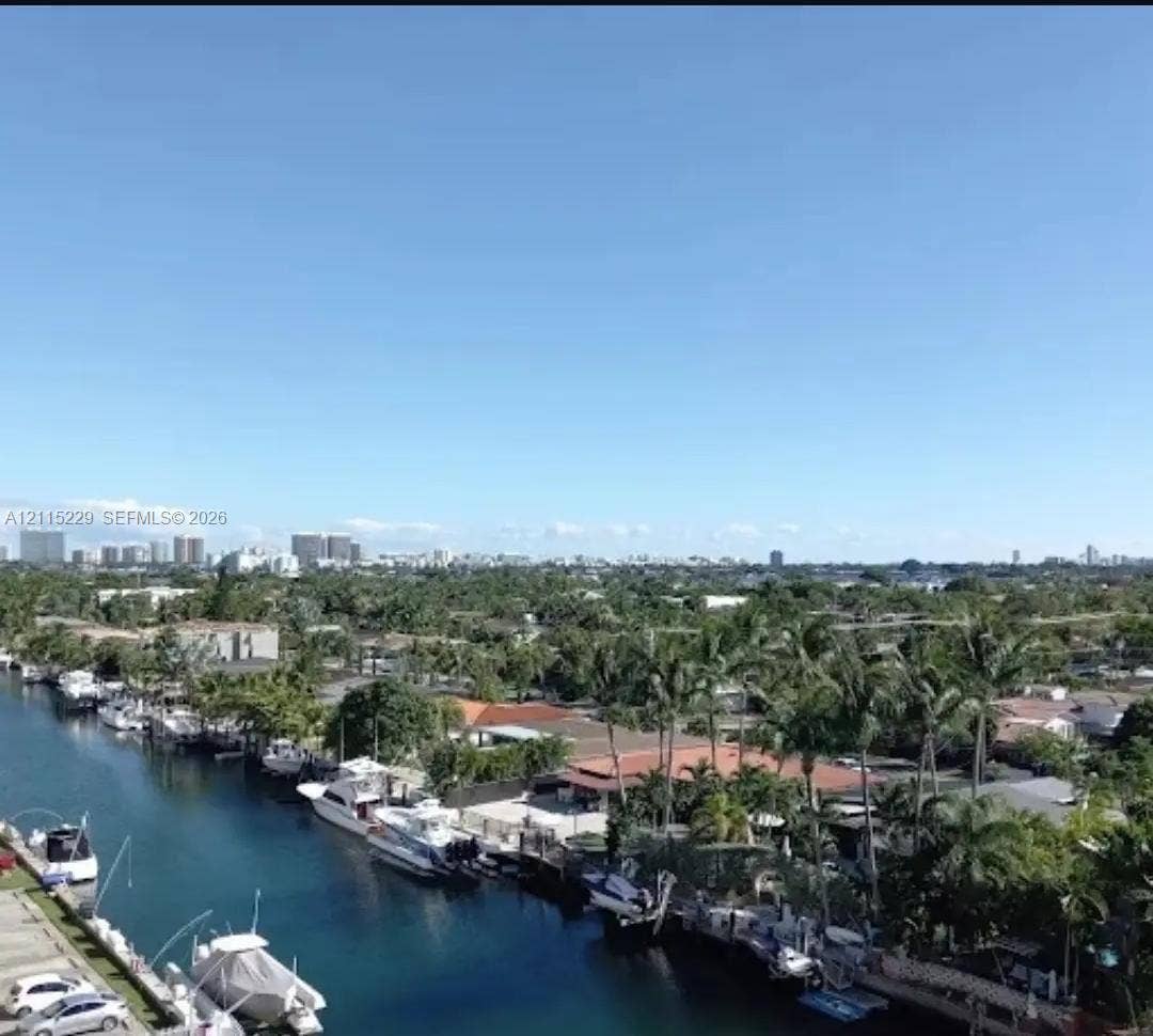 2020 NE 135th Street, #211, North Miami, FL 33181 Waterfront canal setting with private boat dockage and mature tropical landscaping