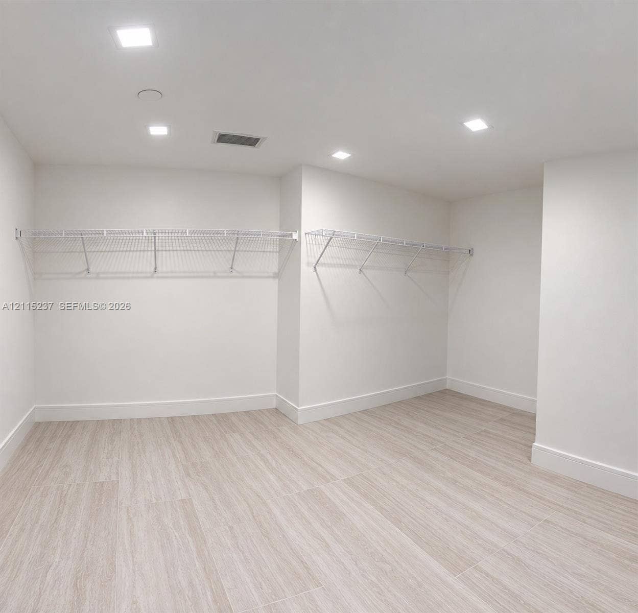 2411 Laguna Circle, #802, North Miami, North Miami, FL 33181 Neutral-toned wood-finish flooring, recessed lighting, and white coated wire shelving