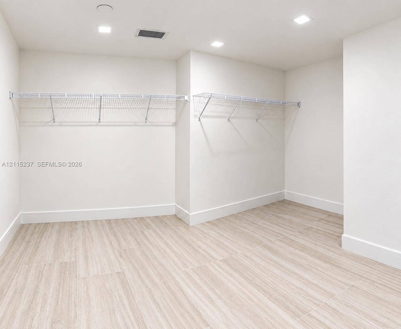 2411 Laguna Circle, #802, North Miami, North Miami, FL 33181 Walk-in storage space featuring wood-finish flooring, white walls, and built-in white wire shelving with integrated lighting