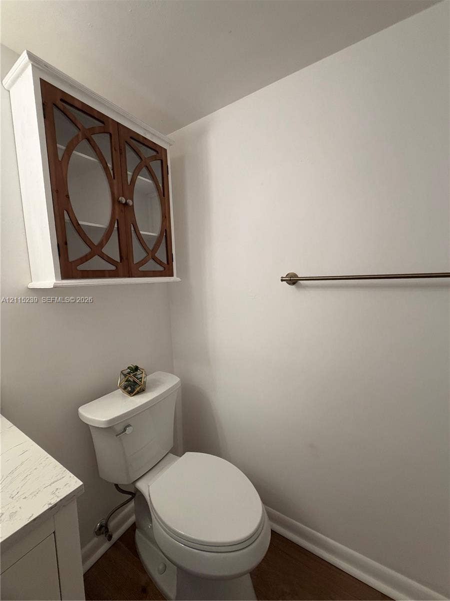 9015 SW 138th Street, #16-2, Miami, Miami, FL 33176 Wall-mounted cabinet with decorative wood-overlay glass doors, stone-finish vanity countertop, and brushed nickel hardware