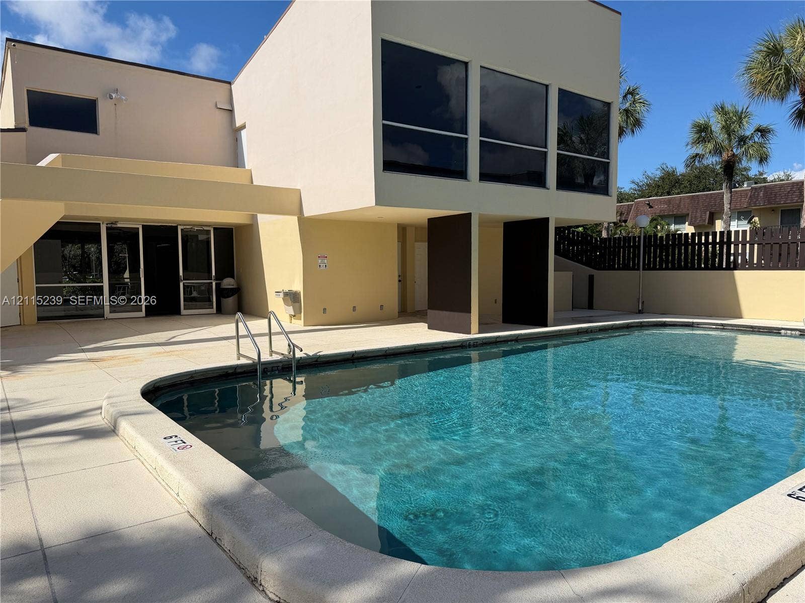 9015 SW 138th Street, #16-2, Miami, Miami, FL 33176 Swimming pool with concrete decking, multi-story exterior architecture, and privacy fencing