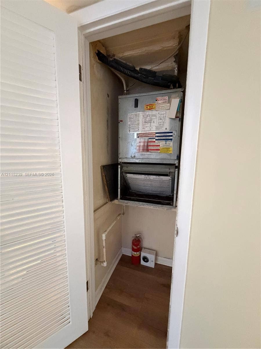 9015 SW 138th Street, #16-2, Miami, Miami, FL 33176 Mechanical closet featuring an HVAC air handler unit and wood-finish flooring