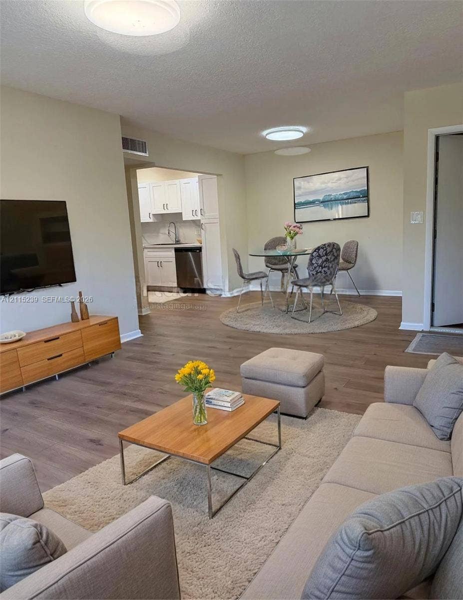 9015 SW 138th Street, #16-2, Miami, Miami, FL 33176 Open-concept interior featuring wood-finish flooring, recessed lighting, and crisp neutral wall tones
