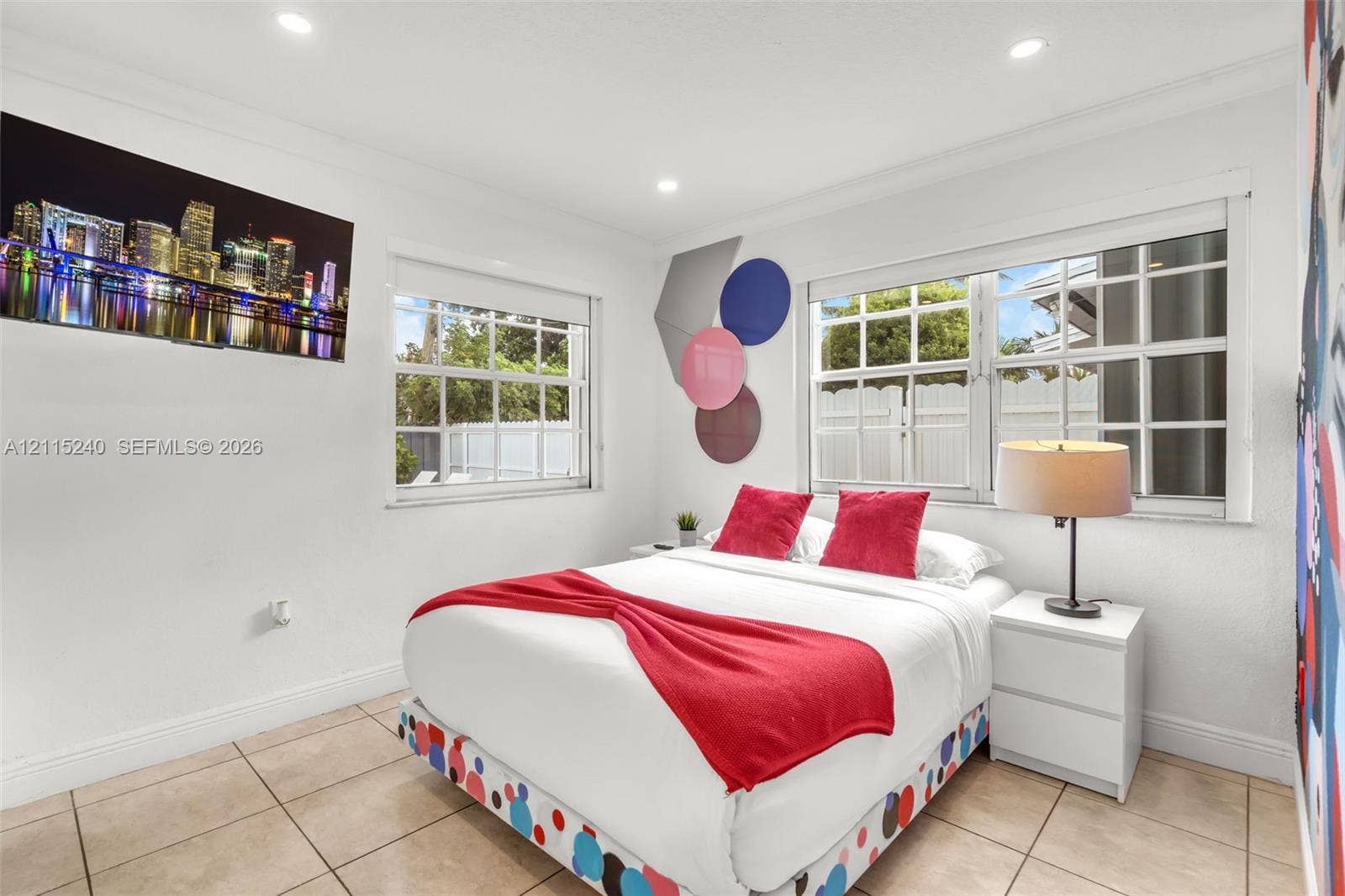 Bright room featuring neutral-toned tile flooring, recessed ceiling lighting, and two multi-pane windows with grid detailing