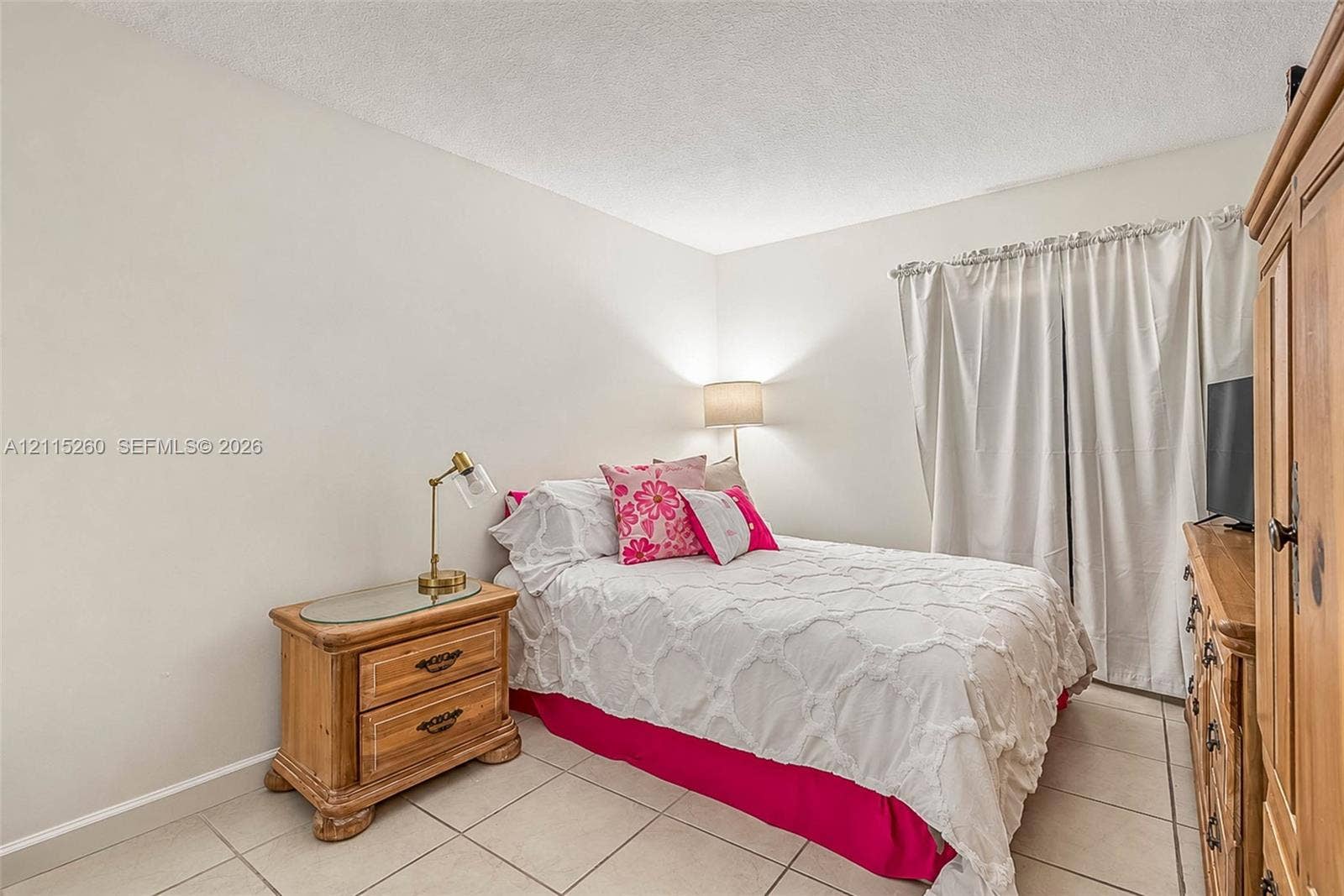 820 NW 132nd Court, Miami, FL 33182 Neutral-toned walls, ceramic tile flooring, and floor-to-ceiling drapery