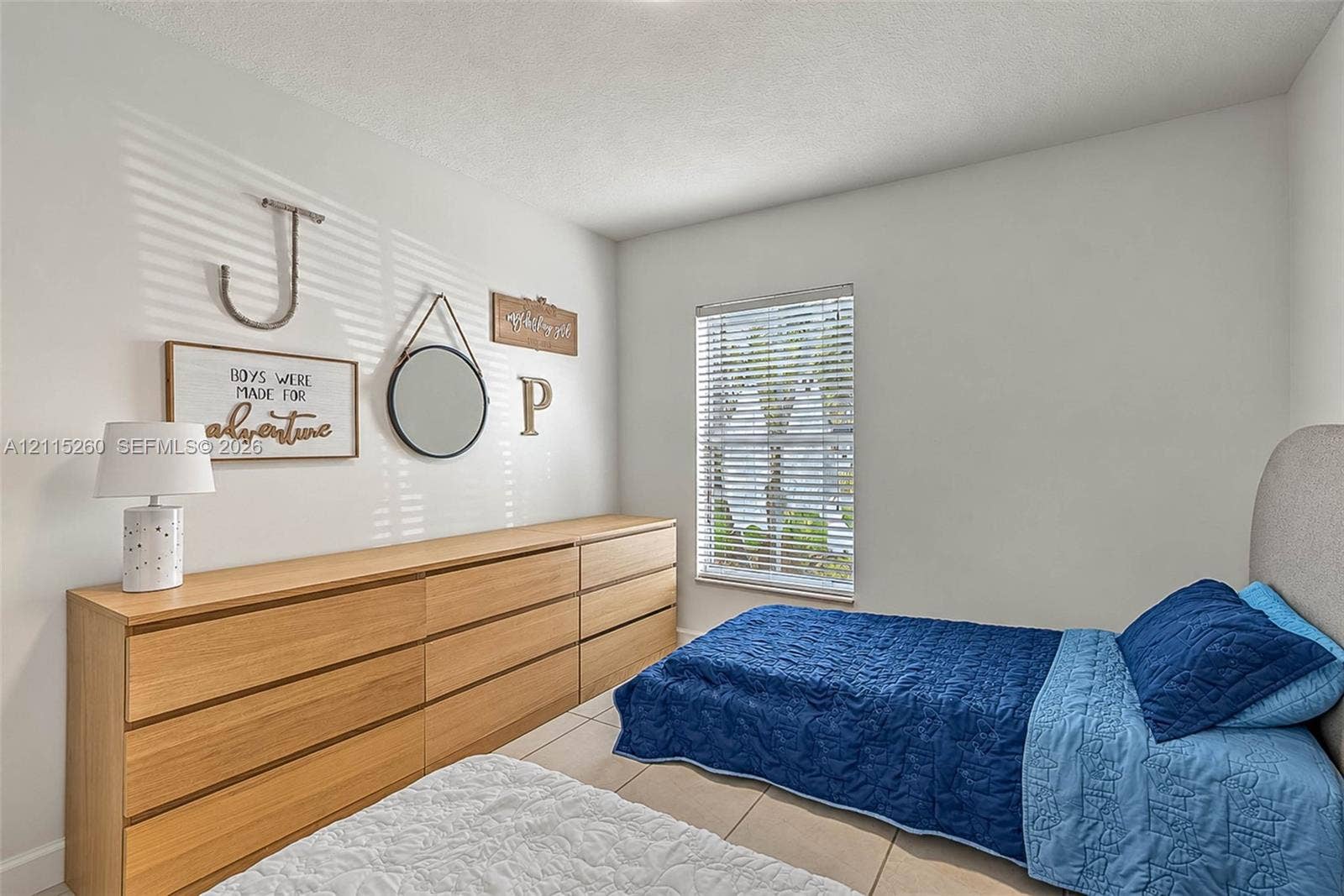 820 NW 132nd Court, Miami, FL 33182 Room featuring neutral walls, large-format tile flooring, and a single-pane window with horizontal blinds