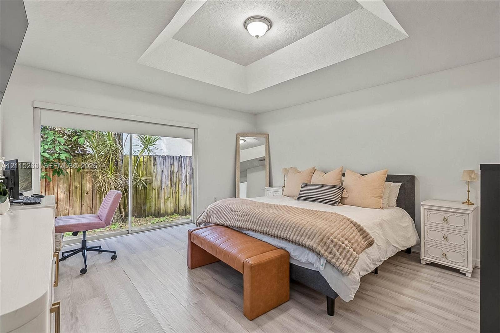 820 NW 132nd Court, Miami, FL 33182 Tray ceiling, wood-finish flooring, and sliding glass doors leading to exterior space