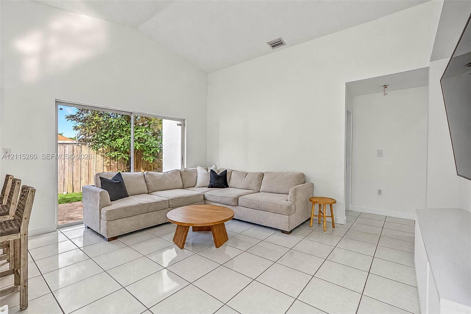 820 NW 132nd Court, Miami, FL 33182 Vaulted ceiling, large sliding glass doors, and polished tile flooring