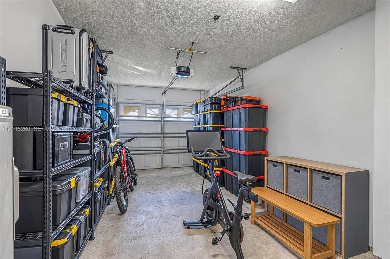 820 NW 132nd Court, Miami, FL 33182 Enclosed garage featuring concrete flooring, a paneled overhead door, and painted walls