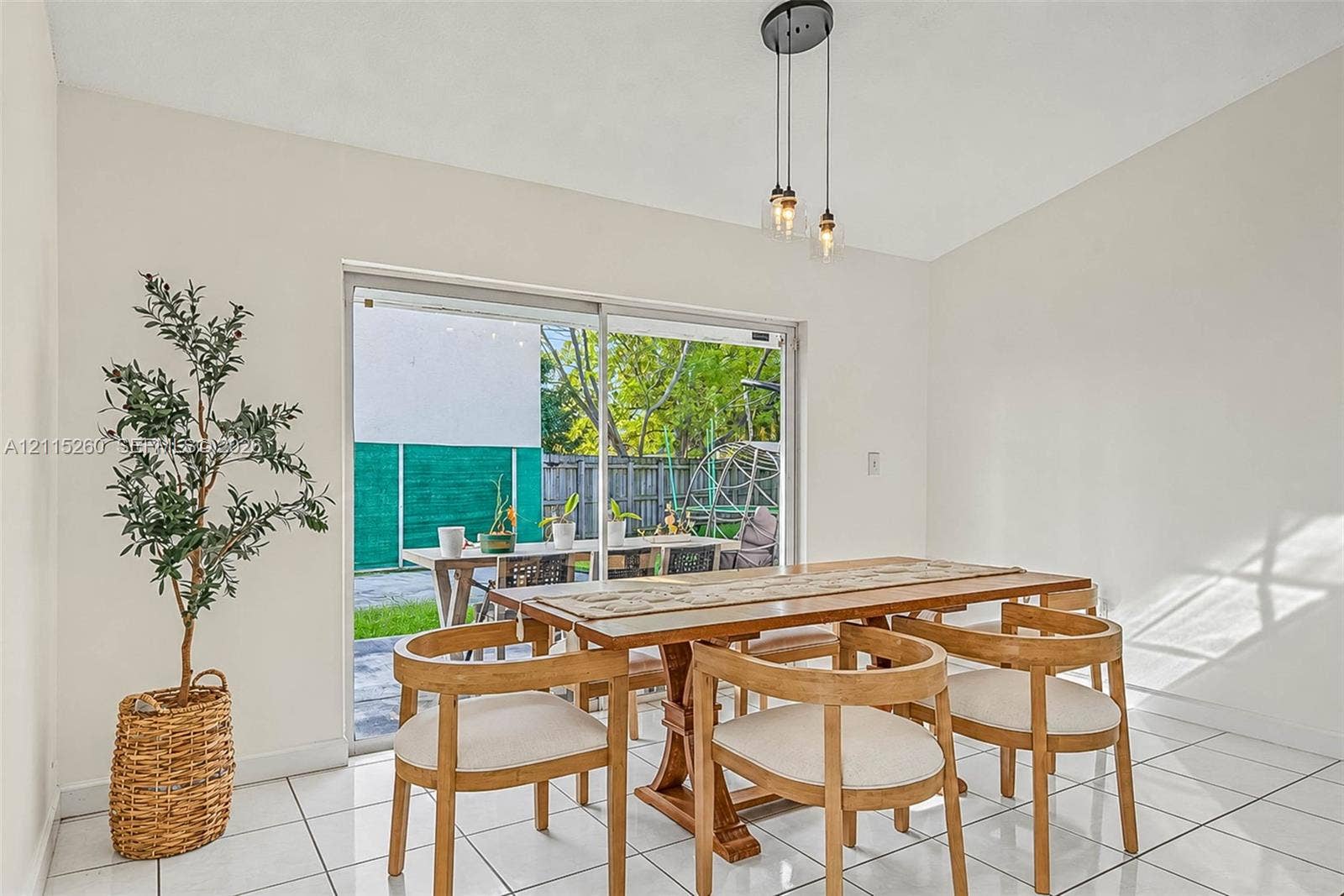 820 NW 132nd Court, Miami, FL 33182 Ceramic tile flooring, multi-light hanging pendant fixture, and large sliding glass door with exterior access