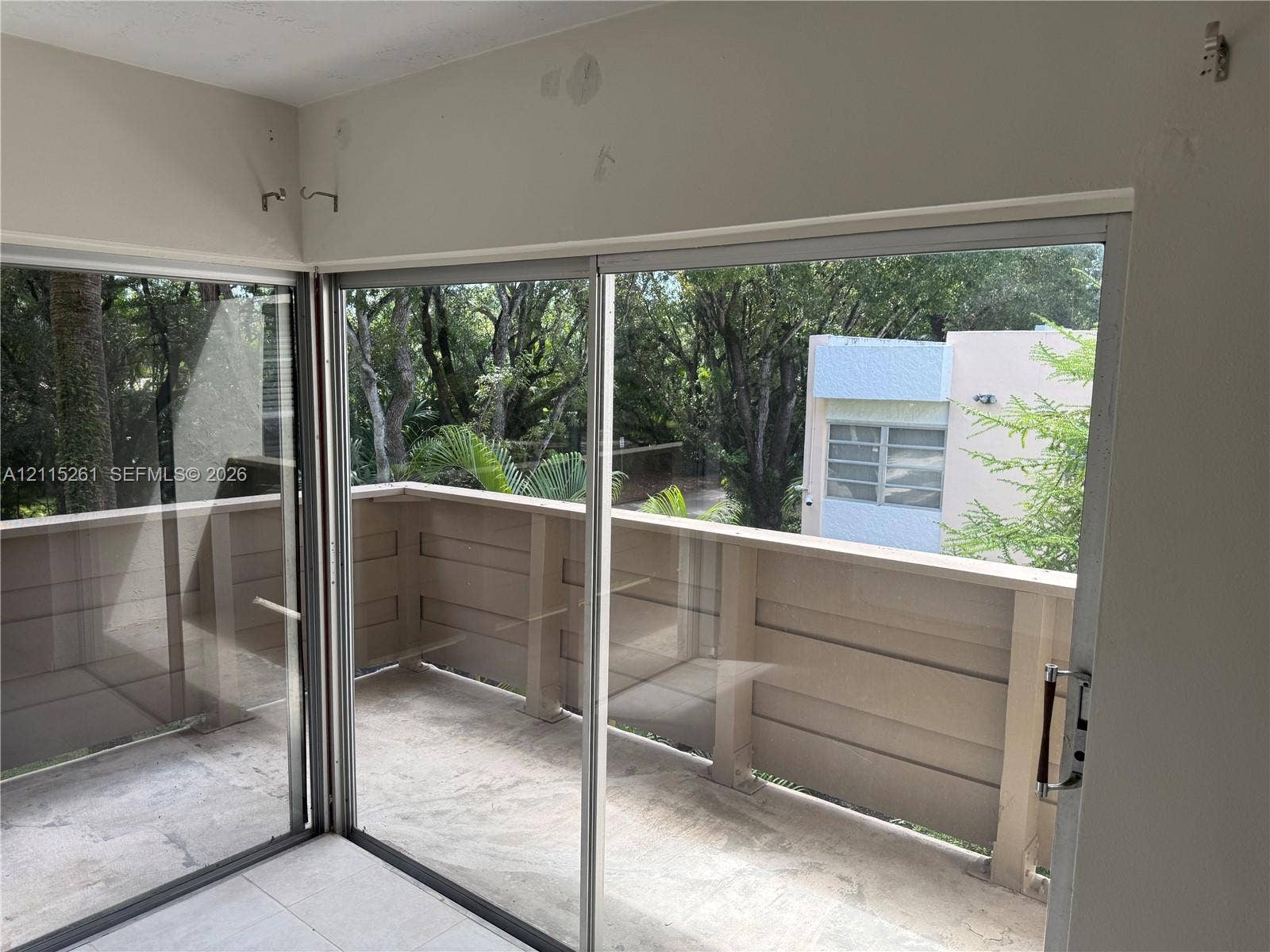1205 Mariposa Avenue, #302, Coral Gables, Coral Gables, FL 33146 Exterior balcony featuring sliding glass doors and solid panel railing